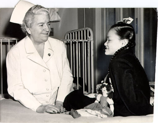 1949 Nurse Anne N. Foye speaking to patient Evelyn Hoey in the Tubercular Unit at San Francisco Hospital
